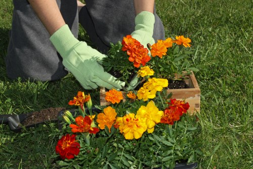 Team of gardeners using hand tools while following safety procedures